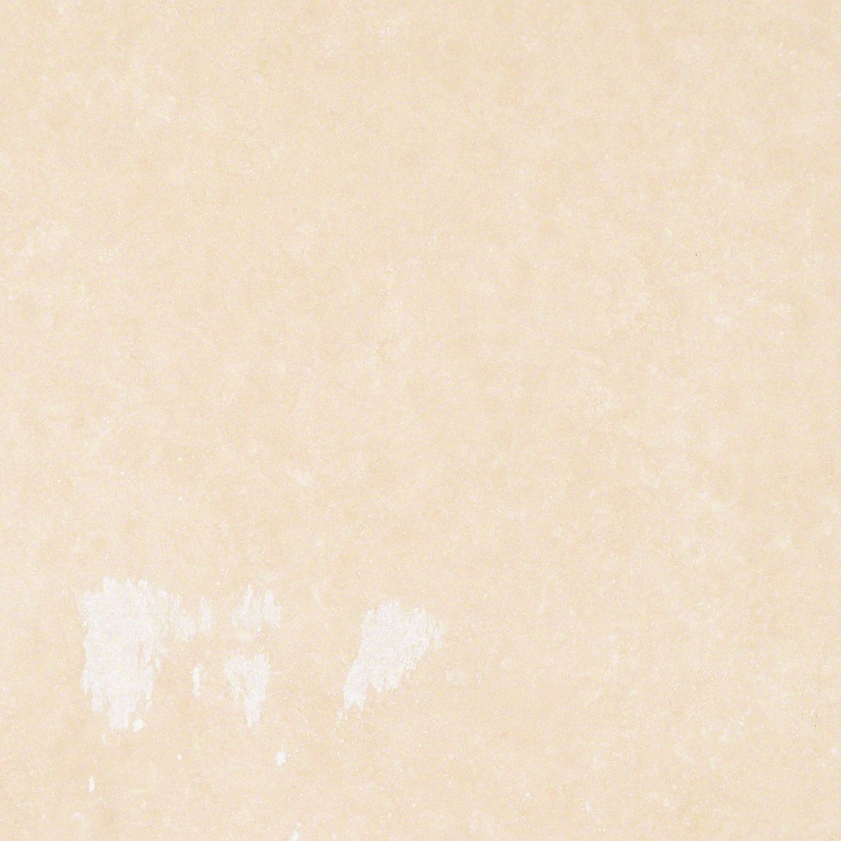 Pale tan textured surface with white splotches near the bottom.