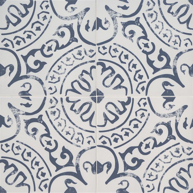 Blue and white patterned tile with a central floral design and circular patterns.