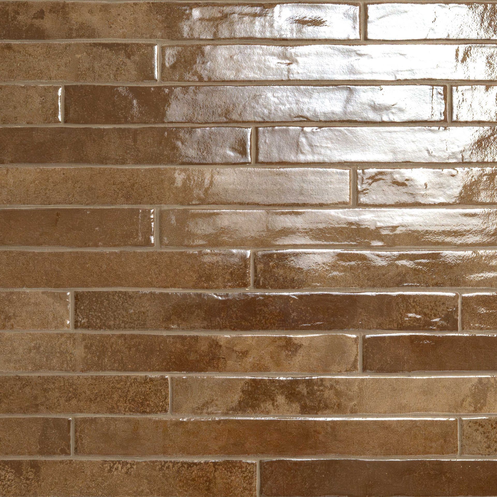 Brick-style tile with a glossy finish. Varying shades of brown with horizontal, rectangular bricks.