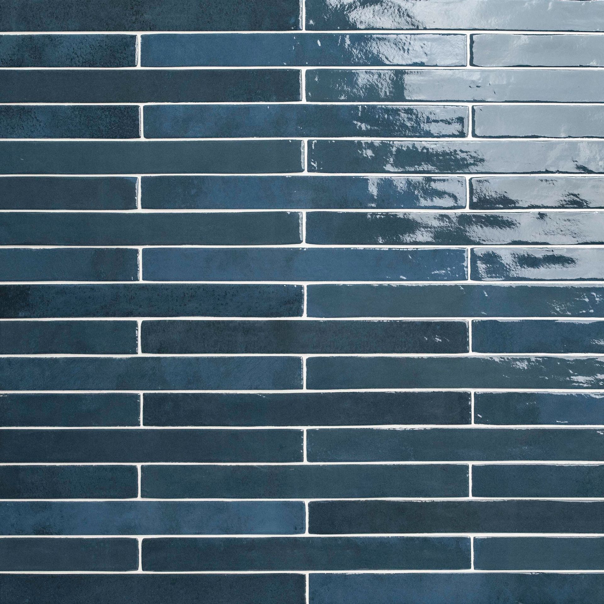 Dark blue and gray brick-like tiles, horizontally stacked, with a distressed finish.