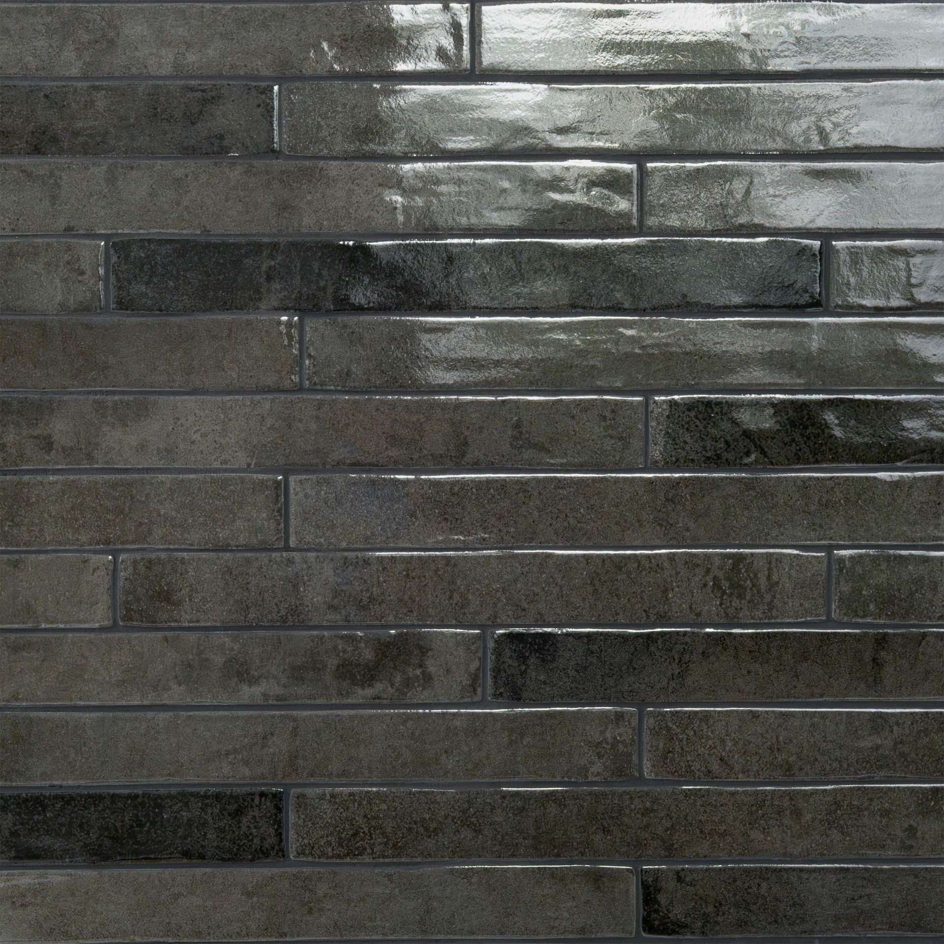 Dark gray brick-like wall tiles with a glossy finish, arranged in a staggered pattern.