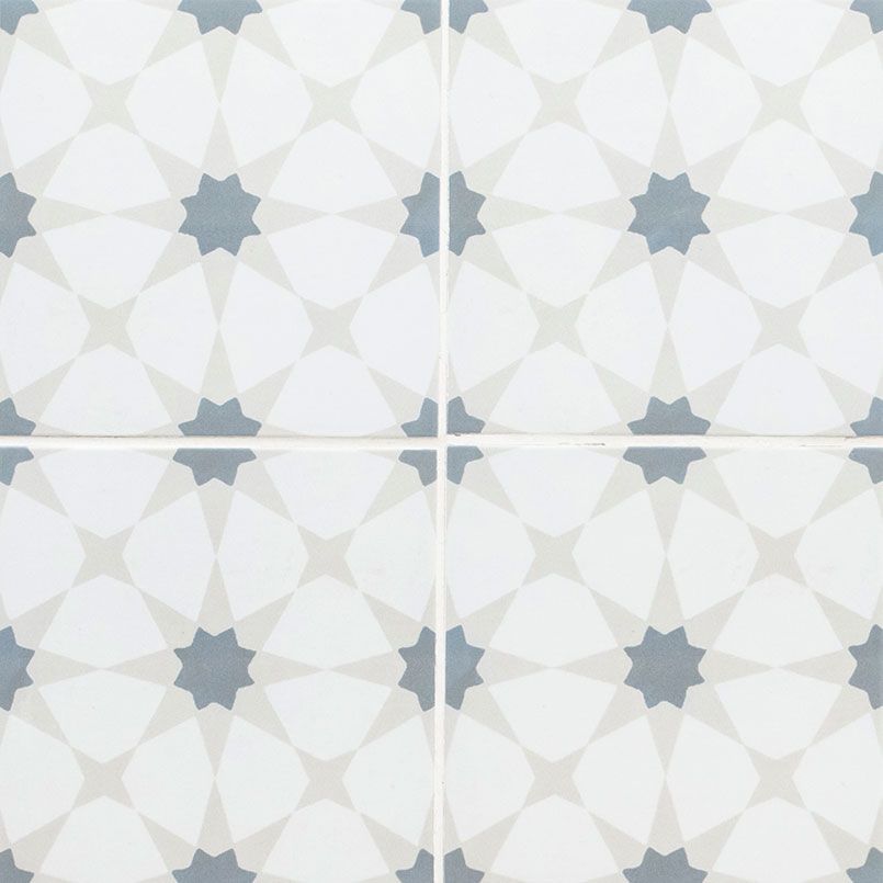 Four white tiles with a repeating pattern of eight-pointed gray stars and petal-like shapes.