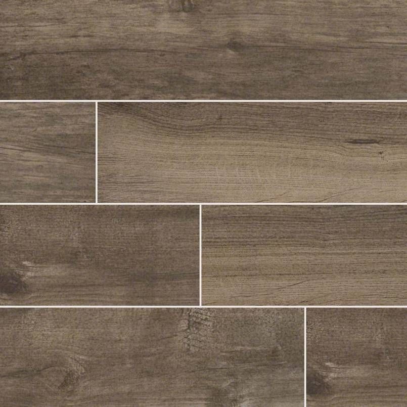 Wood-look tile flooring in shades of brown, with visible wood grain and a white grout line.