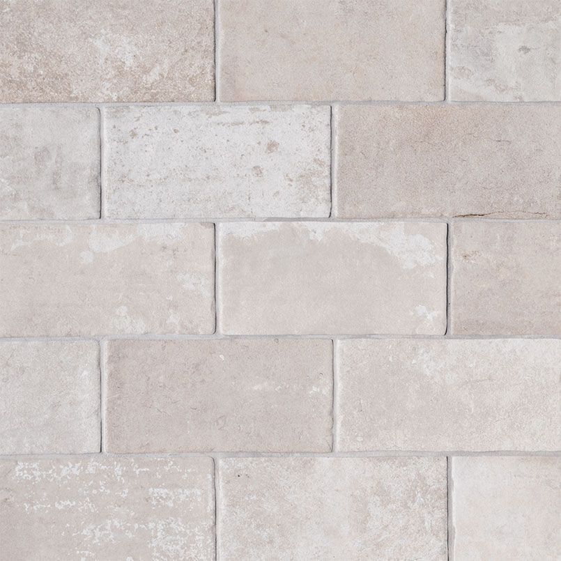 Light beige rectangular brick wall pattern.