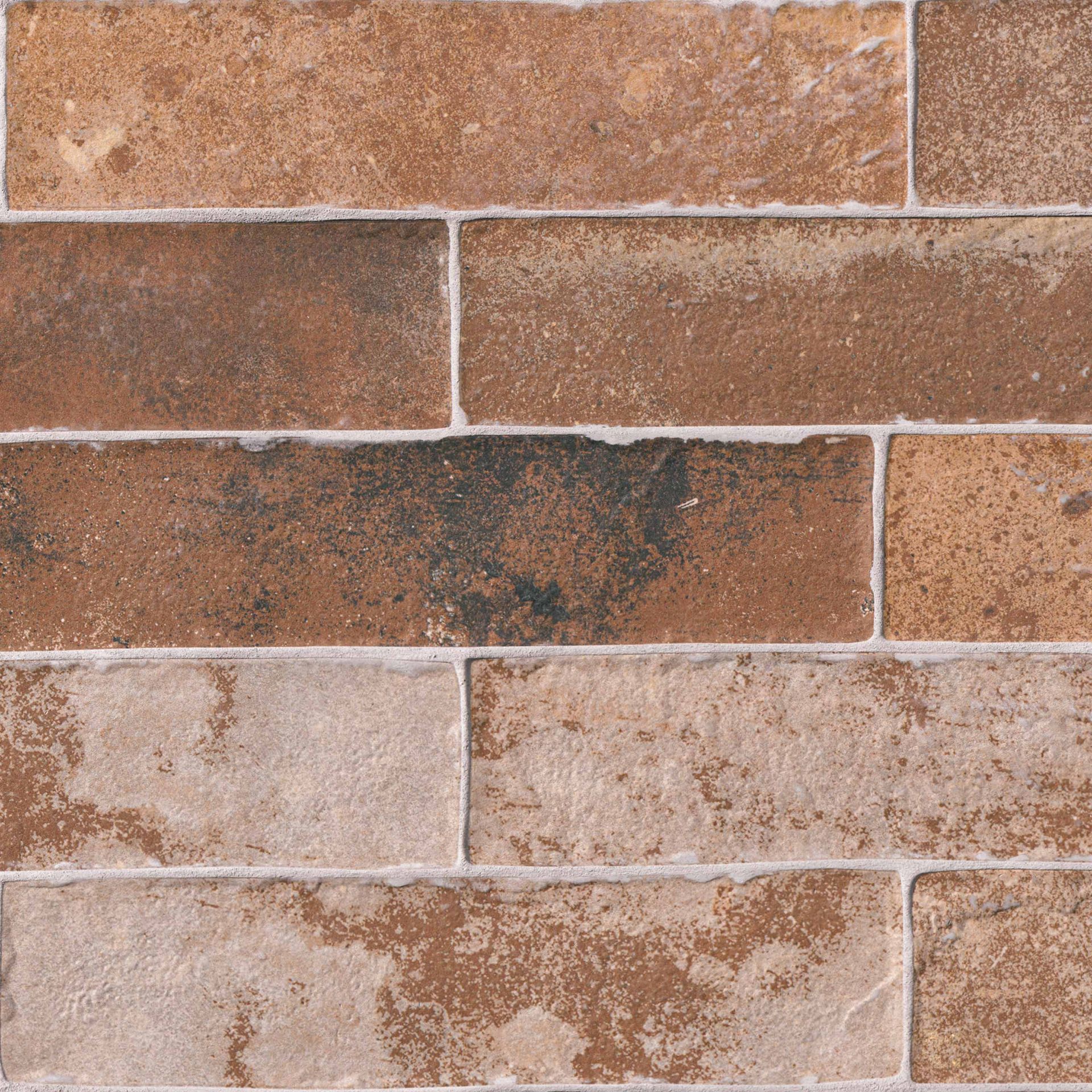 Brick wall with various shades of brown and tan bricks, white mortar.