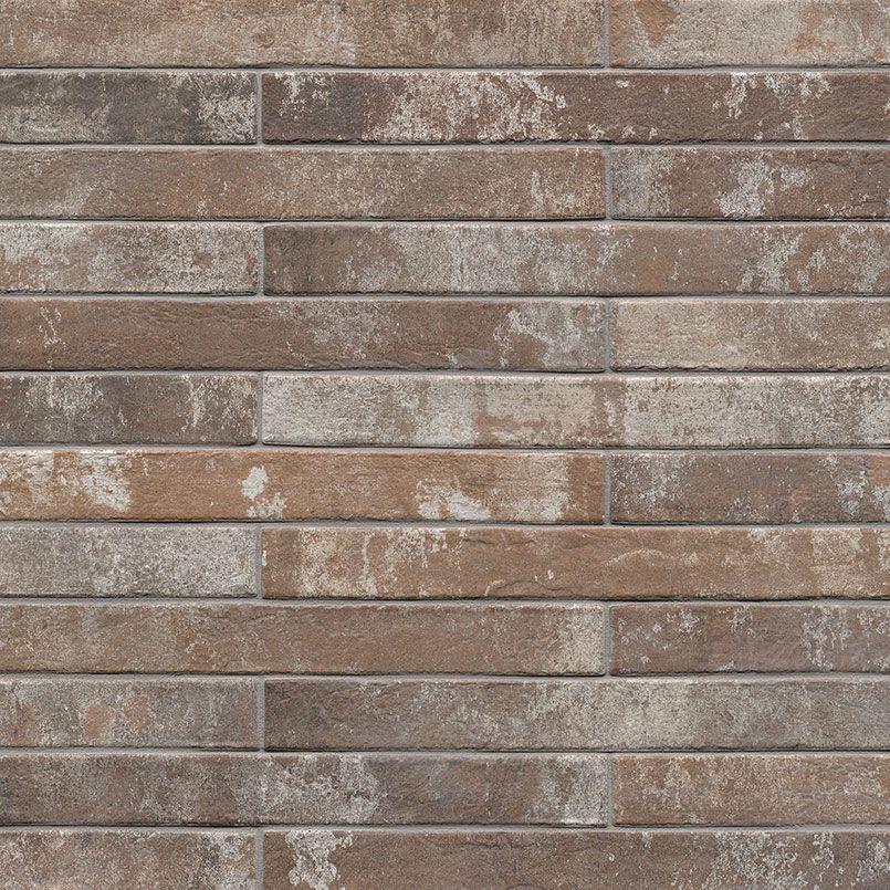 Brick wall with horizontal, varying shades of brown and gray.