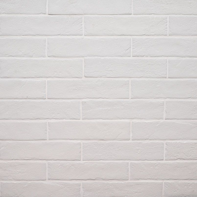 White brick wall with horizontal rectangular bricks and visible grout lines.