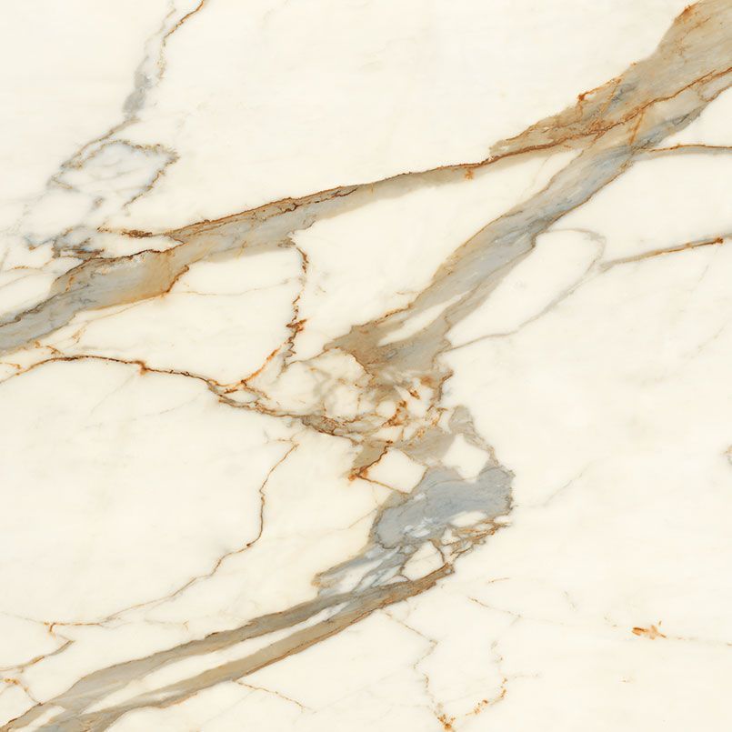 White marble surface with gold and gray veining.