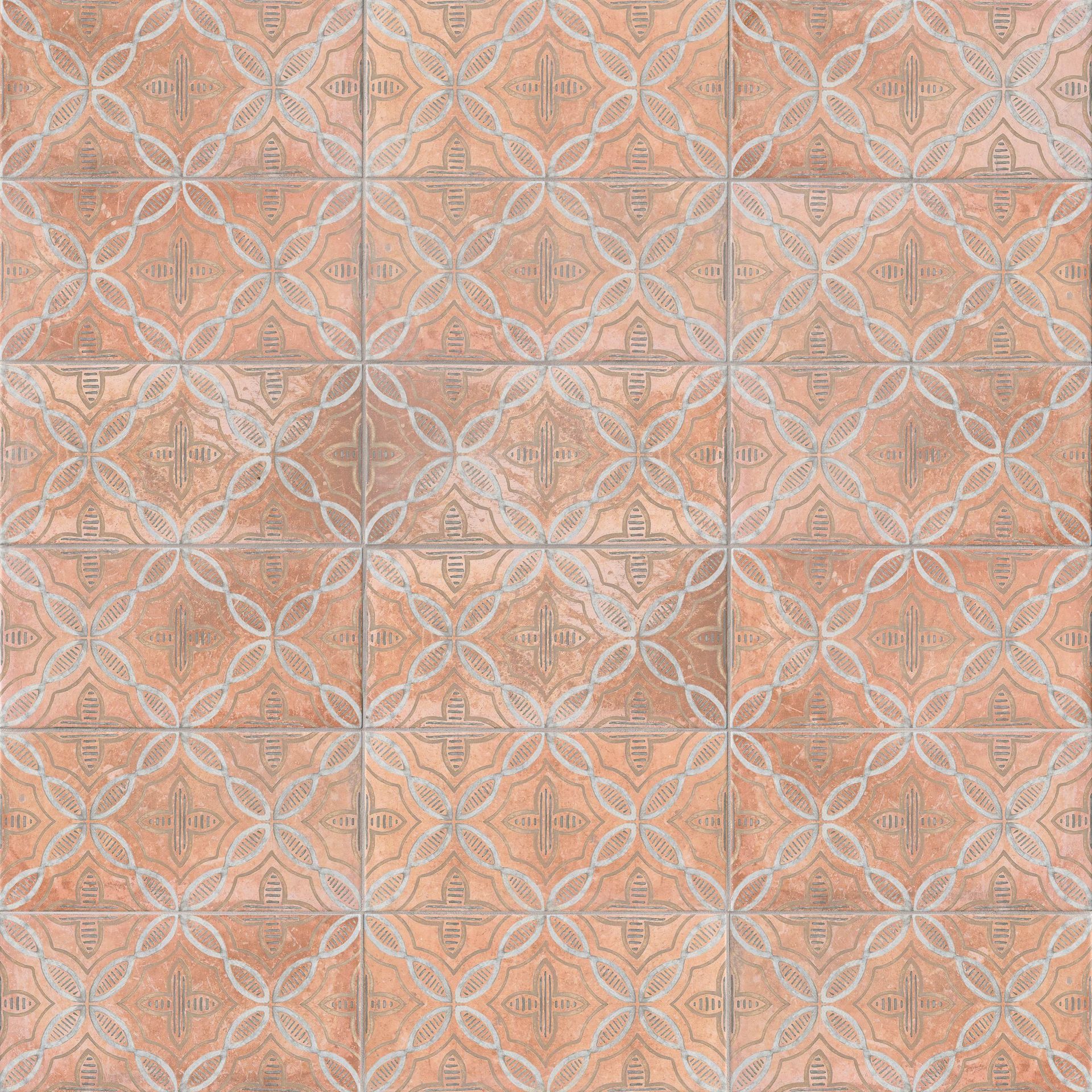 Patterned terracotta tiles in a grid, featuring a repeating floral and diamond motif.