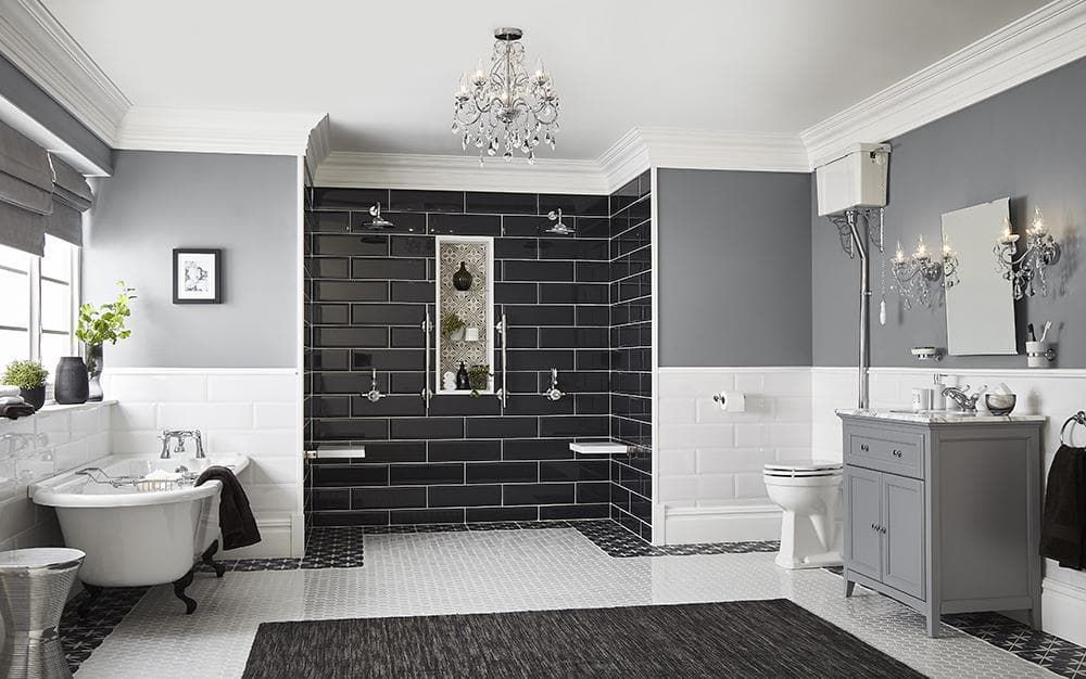 Elegant bathroom with black and white tiles, dark gray walls, a clawfoot tub, and a chandelier.