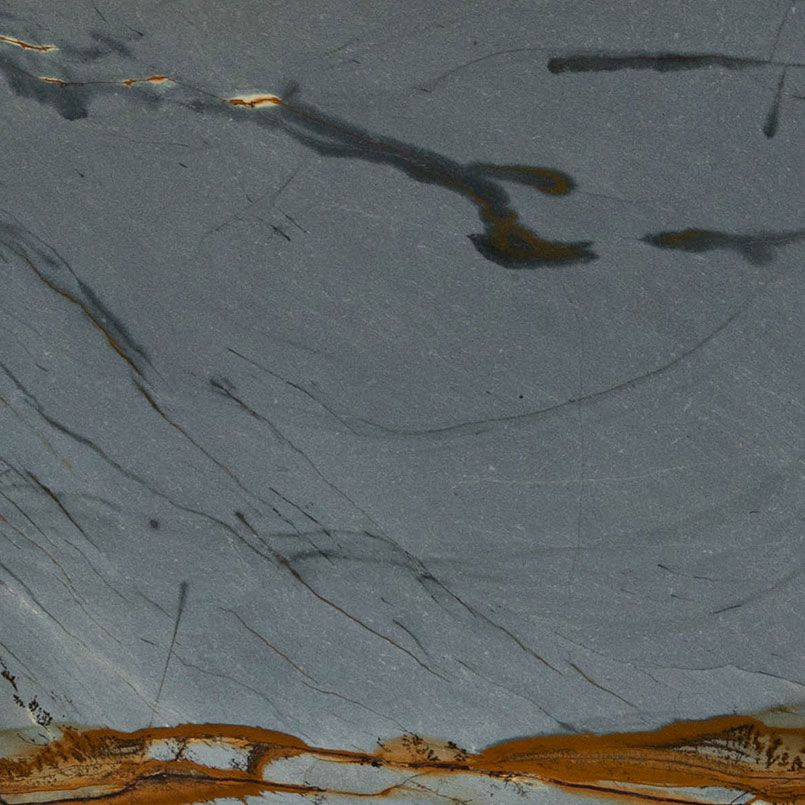 Gray stone surface with brown and gold veins and streaks.