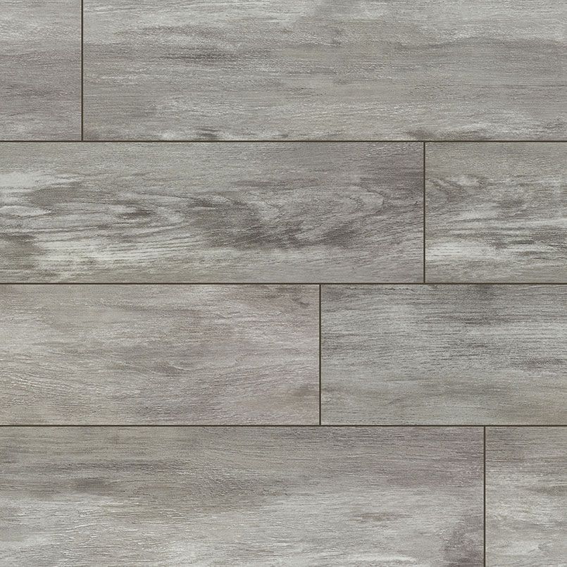 Light gray wooden plank flooring with dark graining and varied lengths.