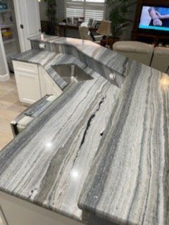 Kitchen countertop with gray and white veined pattern, built-in sink.