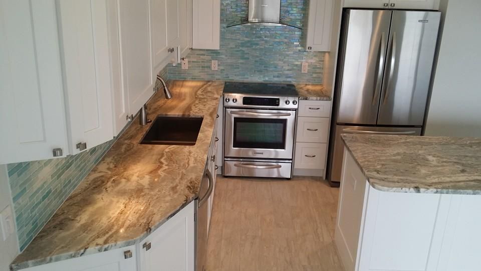 Kitchen with white cabinets, stainless steel appliances, and granite countertops.