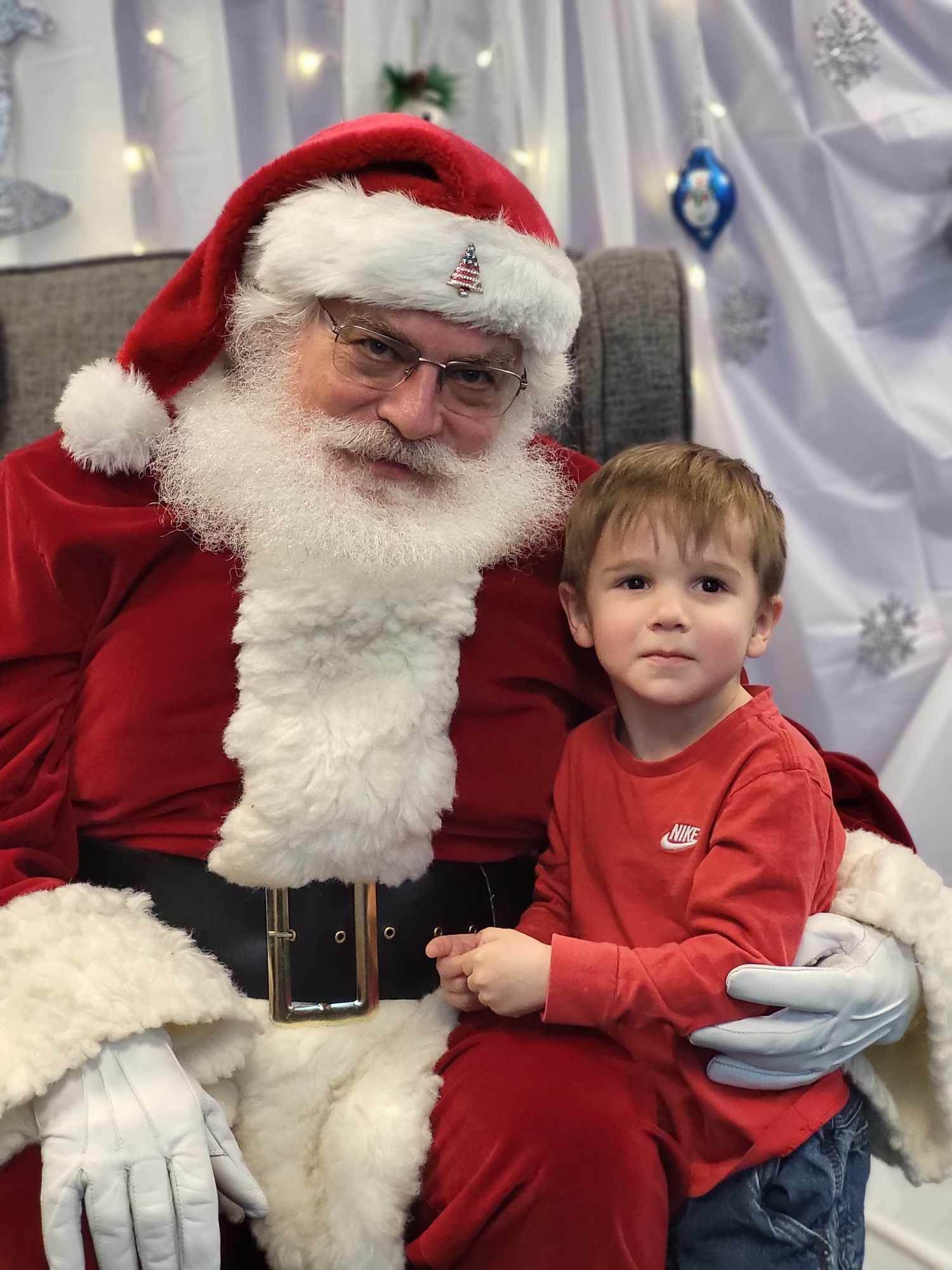 A little boy is sitting on santa 's lap.