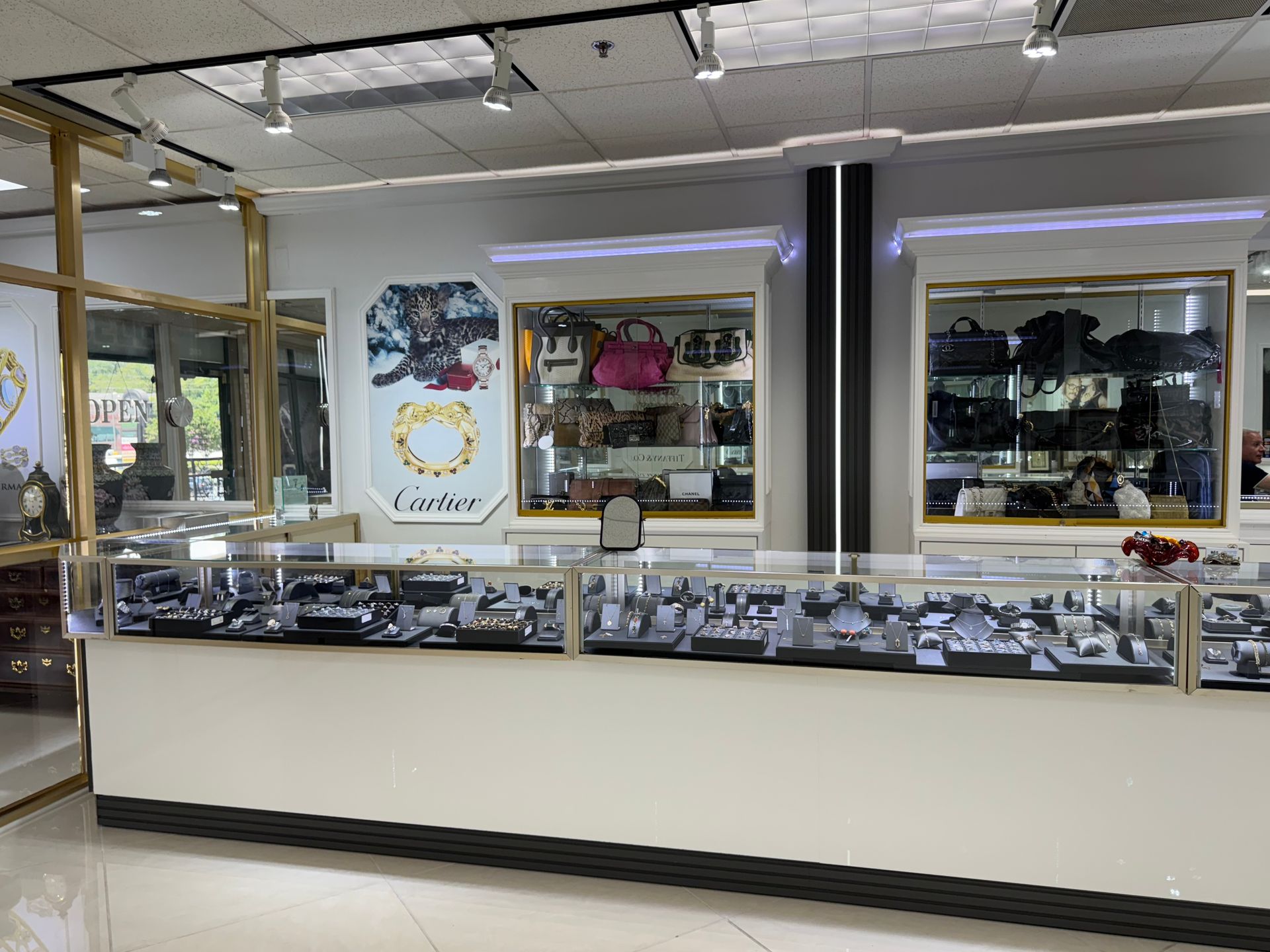 A jewelry store with a long counter and display cases filled with jewelry.
