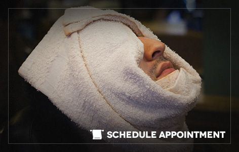 A man with a towel wrapped around his face.