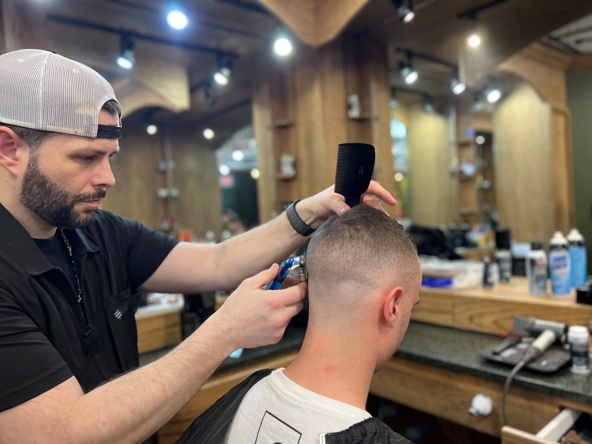 A man is getting a haircut by a barber