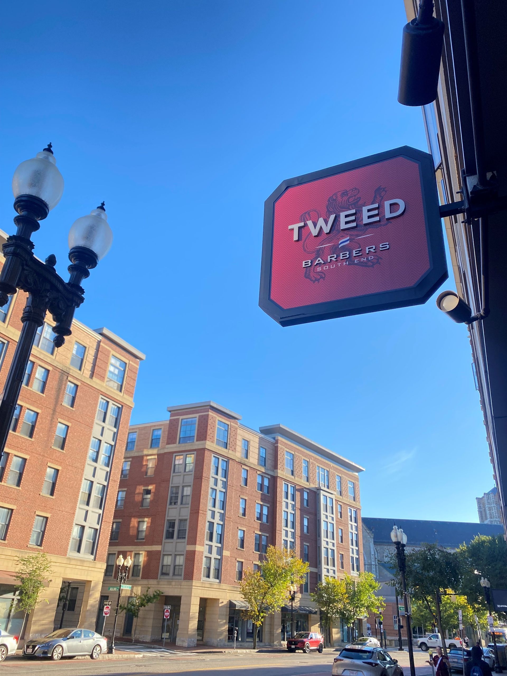 A red and black sign that says Tweed on it