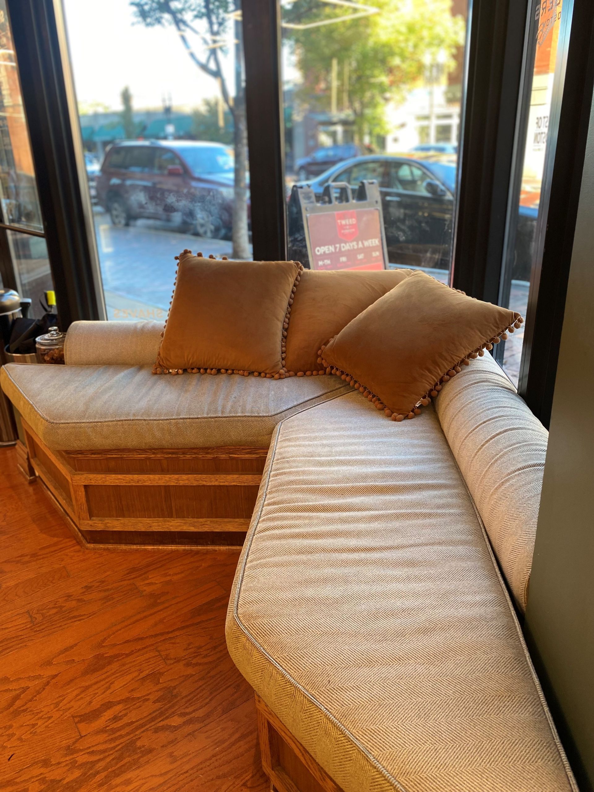 A couch with pillows in a barbershop