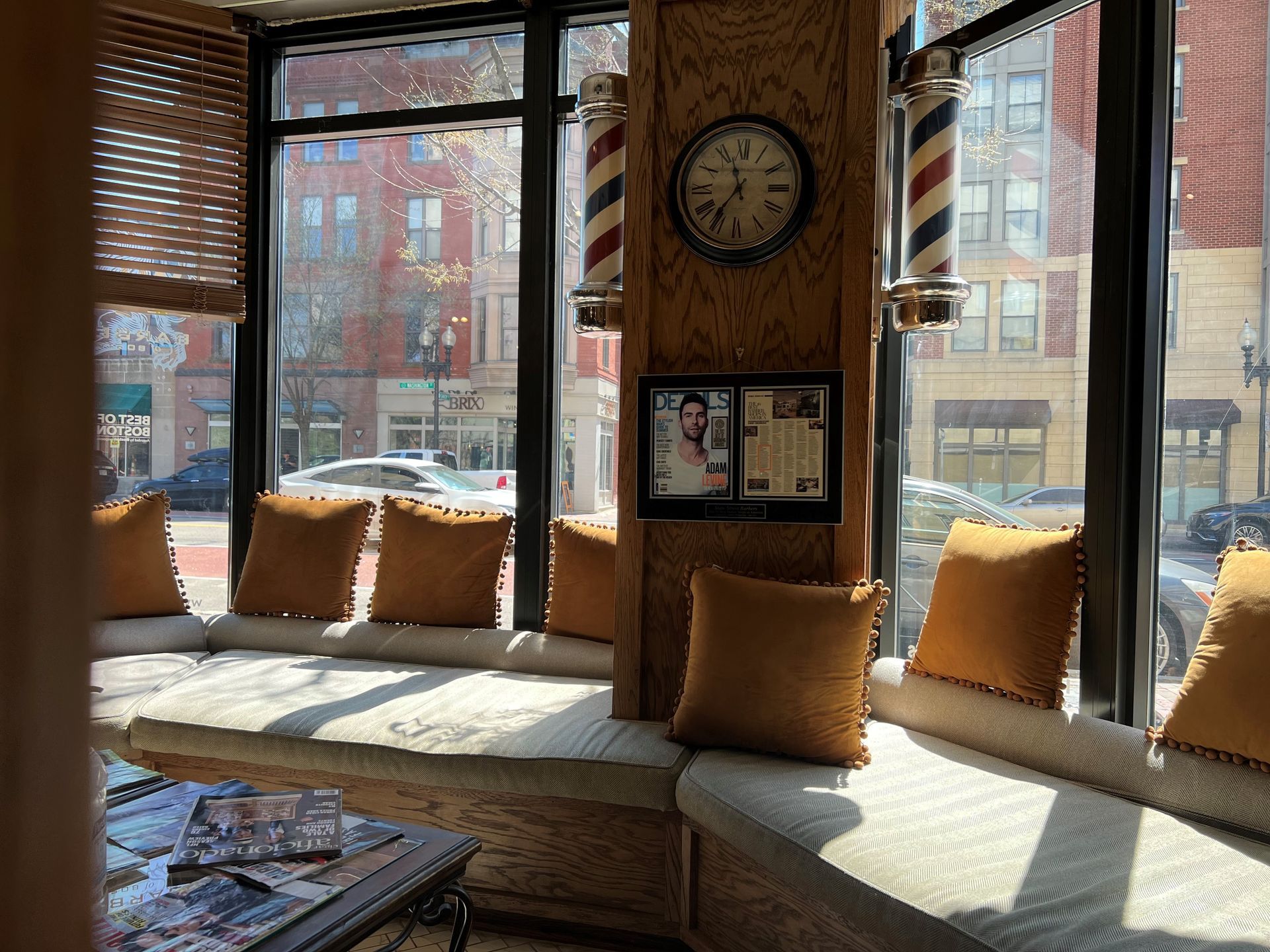 A barbershop with a large window and a clock on the wall