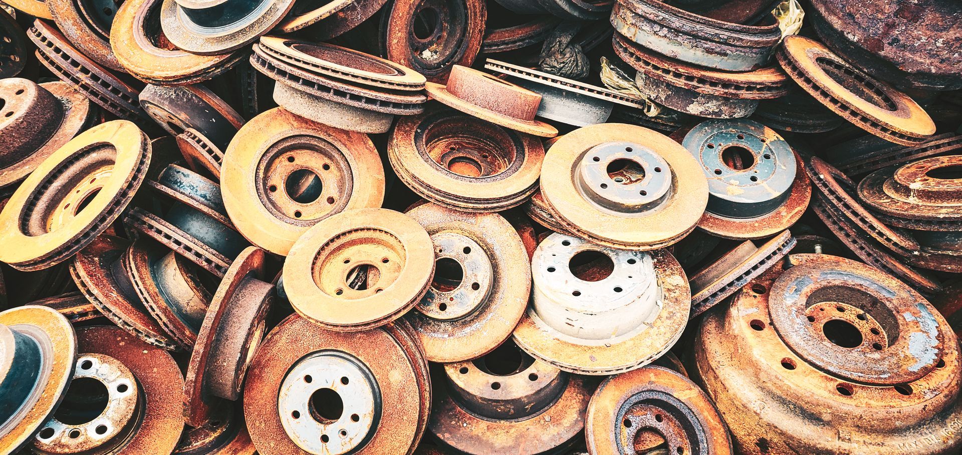 Pile of rusty car brake rotors.