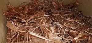 Scrap copper: wires and plates in a container.