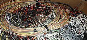 A tangled pile of colorful wires and cables, possibly for electronics or networking.