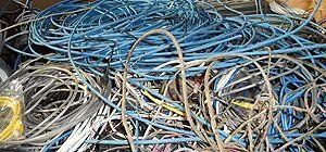 Tangled pile of blue, gray, and yellow cables.