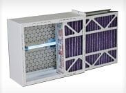 Open HVAC air filter cabinet with two purple pleated filters inside and one panel open.