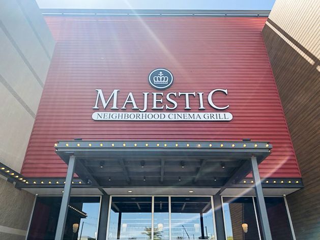 Majestic Neighborhood Cinema Grill exterior. Red building with silver lettering and a crown logo over the entrance.