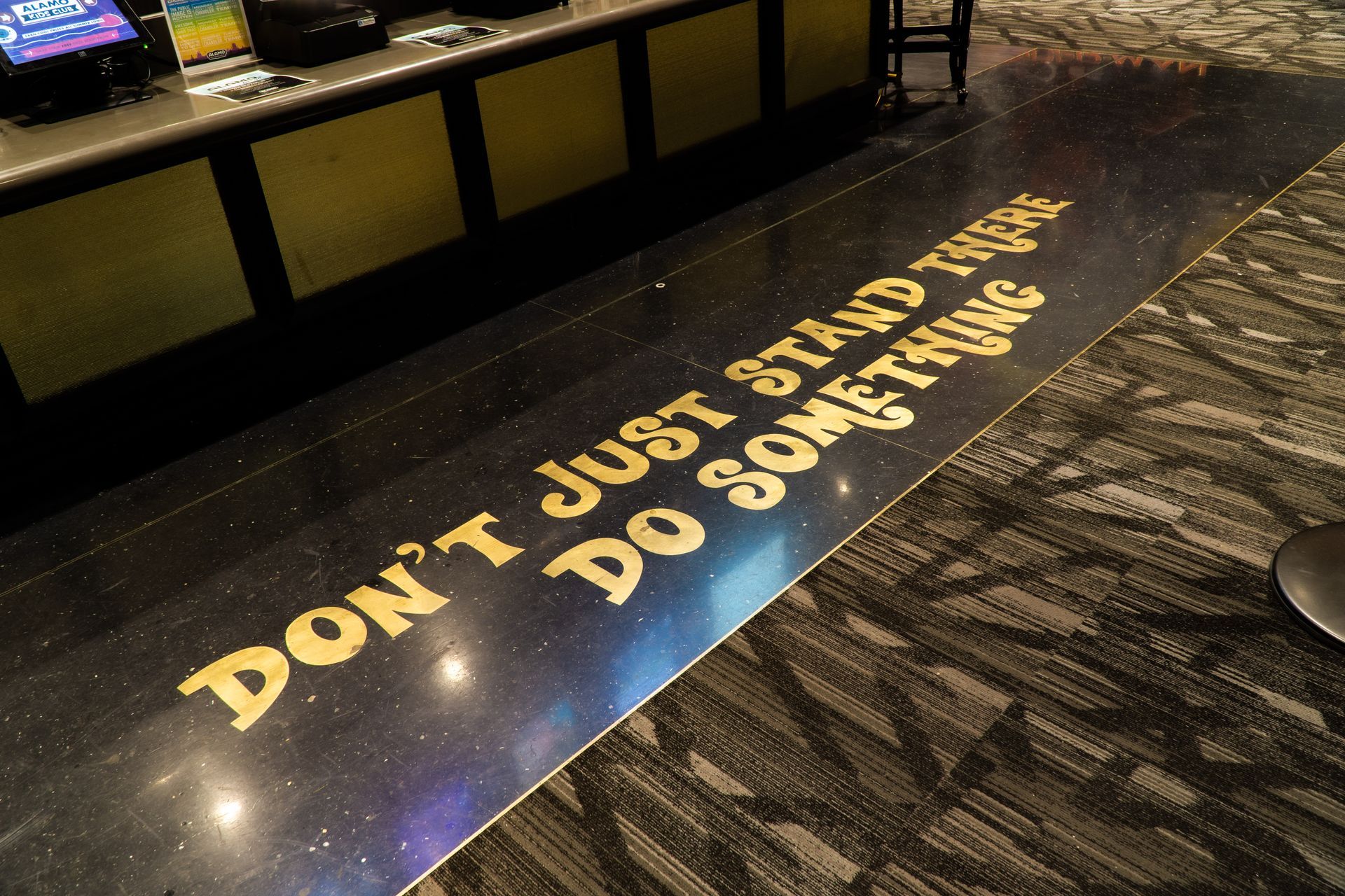 Black floor with gold text: