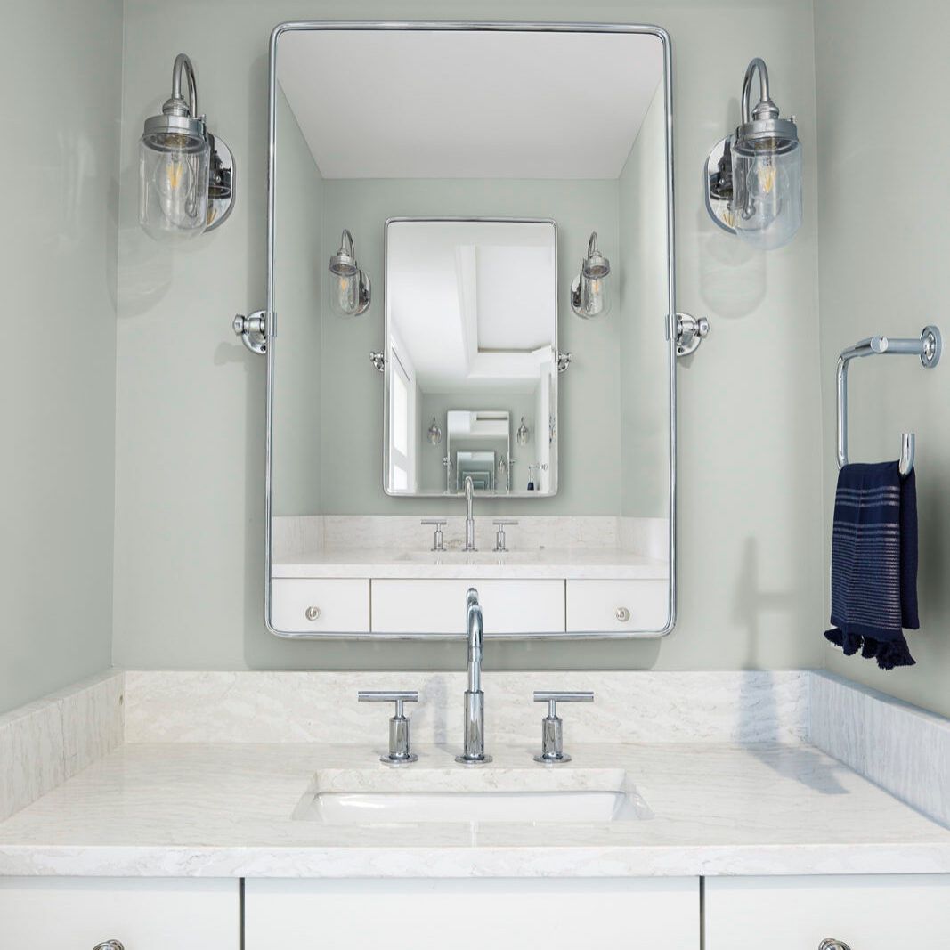 A bathroom sink with a large mirror above it
