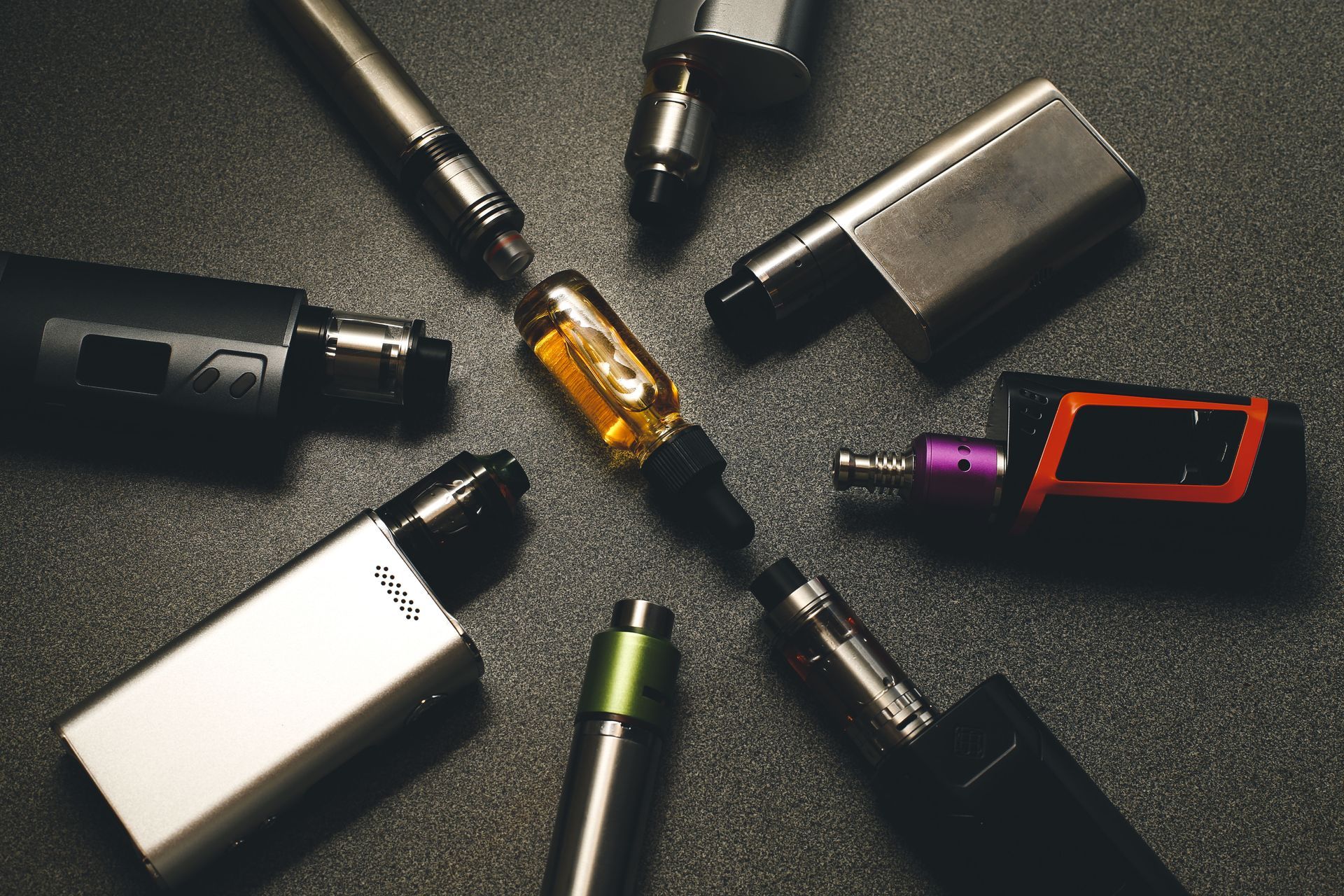 A group of electronic cigarettes are sitting in a circle on a table.