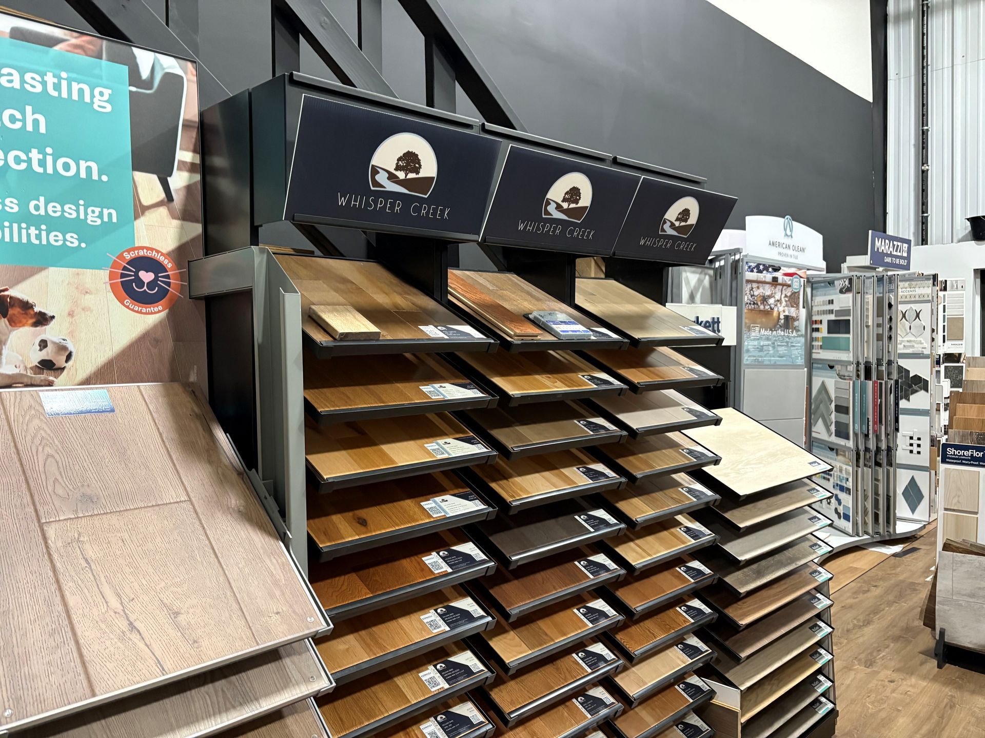 Checkerboard tile flooring installation in progress; black and white tiles, level, tools, and buckets visible.