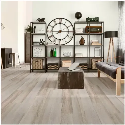 Room with light wood flooring, shelving unit with decor, large clock, and a rustic coffee table.