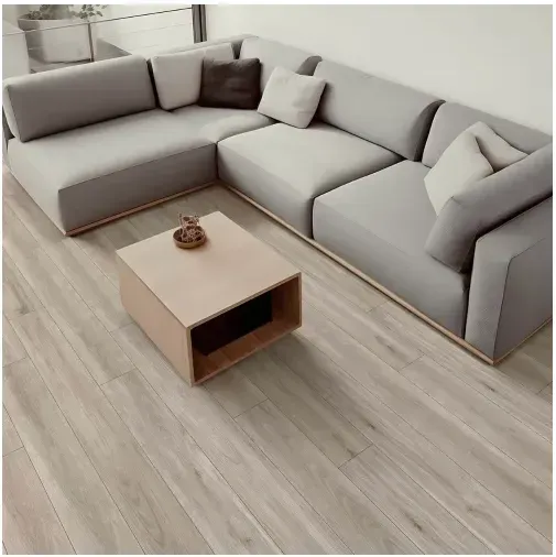 L-shaped gray sofa and a light wood coffee table on a light wood floor. Several pillows.