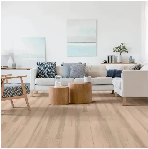 Living room with light wood floors, white sofa, wooden coffee tables, and blue abstract art.