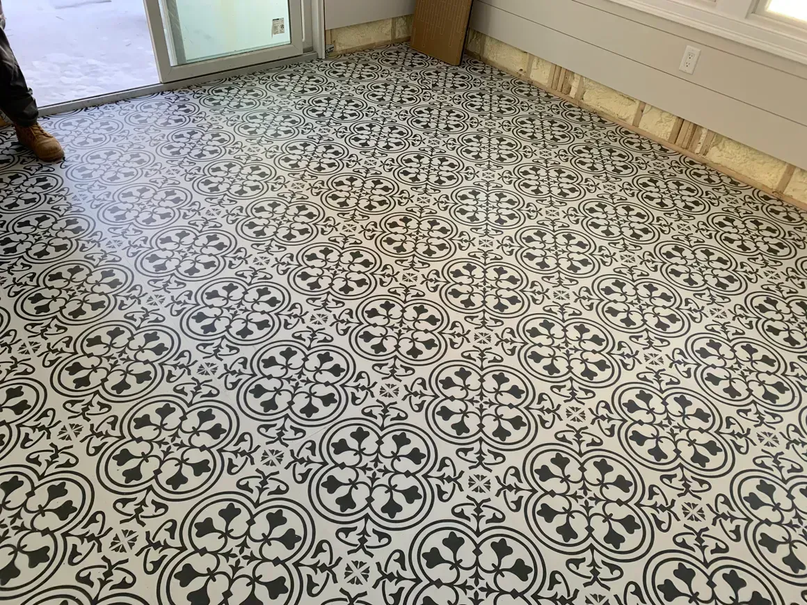 Black and white patterned tile flooring in a room with a sliding glass door.