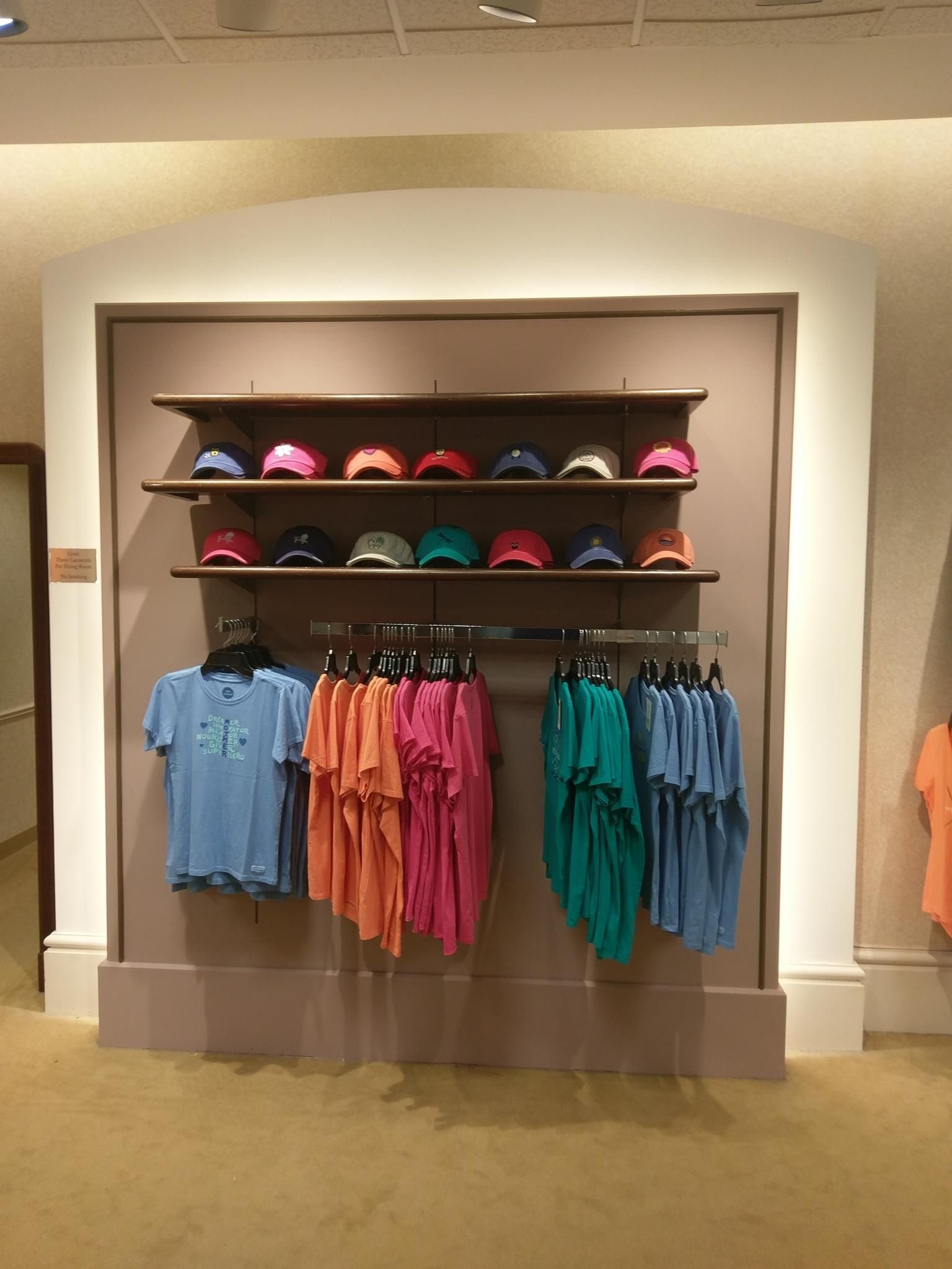 A display of shirts and hats in a store