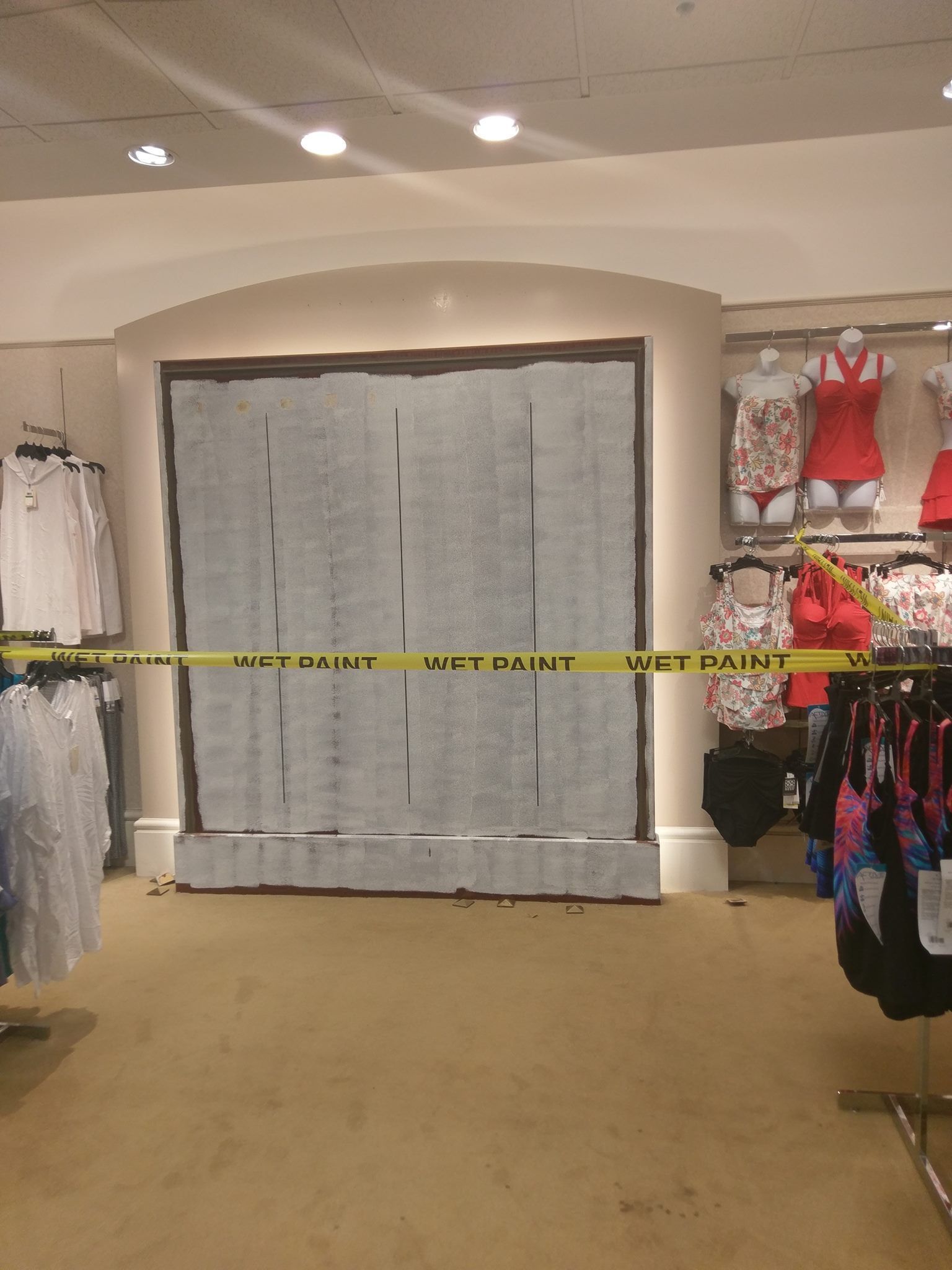 A store with a yellow tape that says get paint on it