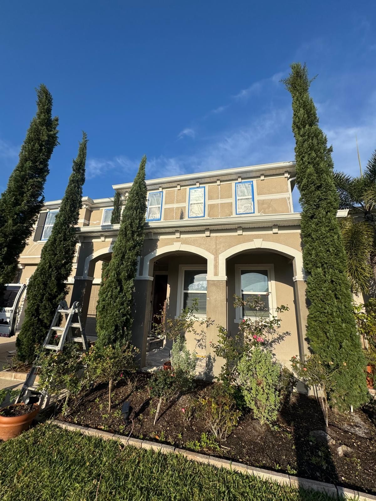 A house with a lot of trees in front of it.