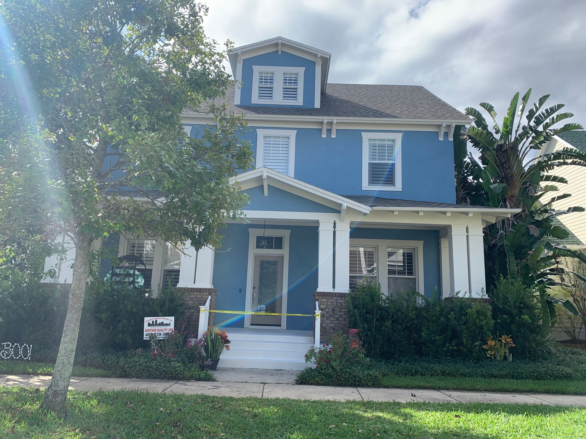 A blue house with white trim is for sale