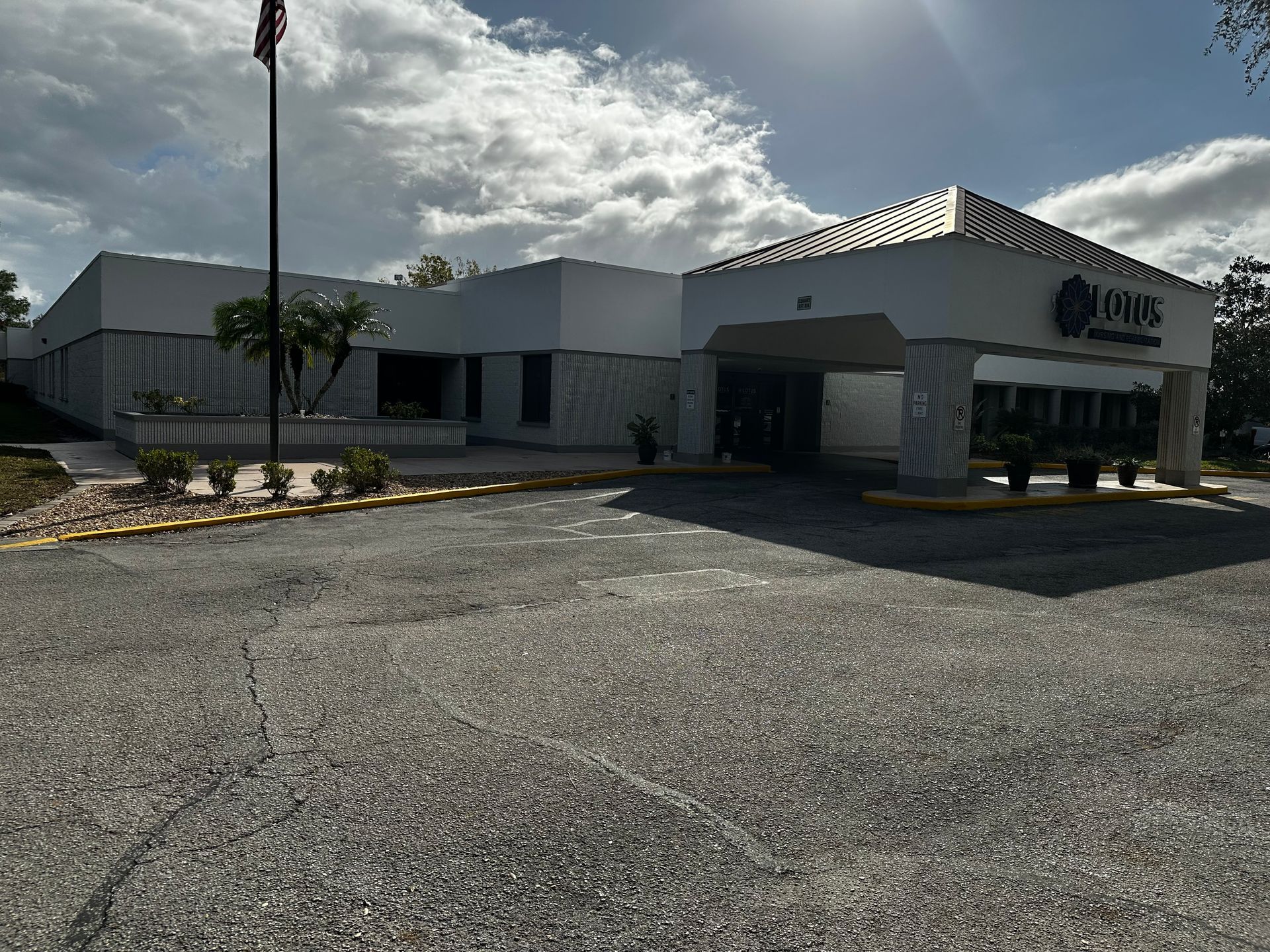 A large white building with a flag in front of it.