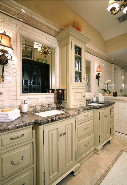 Bathroom with cream cabinets, brown countertop, and a large mirror.