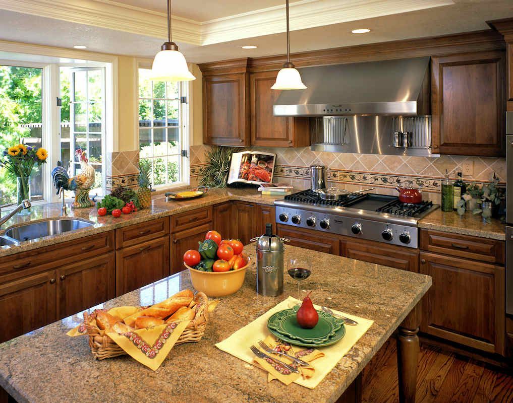 Kitchen with wooden cabinets, granite countertops, and stainless steel appliances.