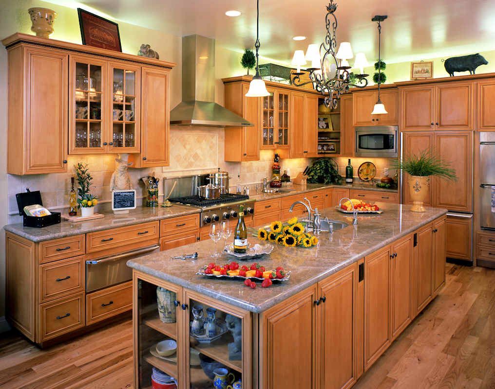 Spacious kitchen with wood cabinets, island, stainless steel appliances, and a chandelier.