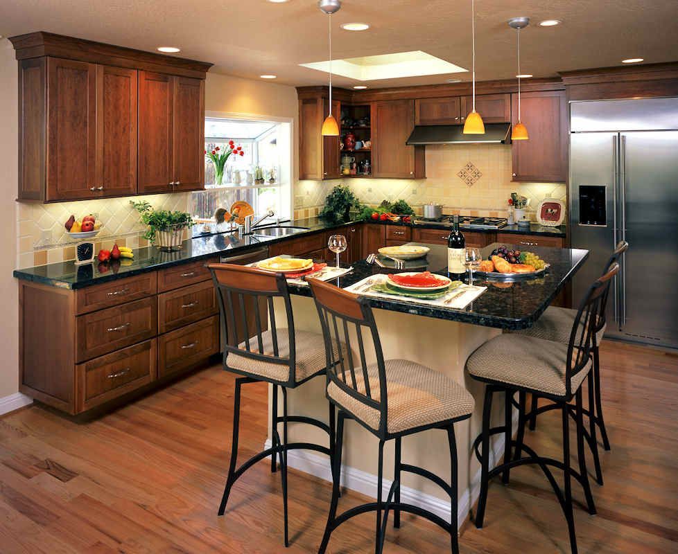 Kitchen with wooden cabinets, granite countertops, and a central island with bar stools.