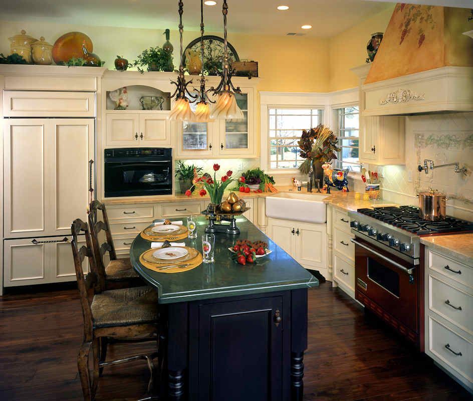 Elegant kitchen with island, dark cabinets, dark countertop, and dark wood floors.