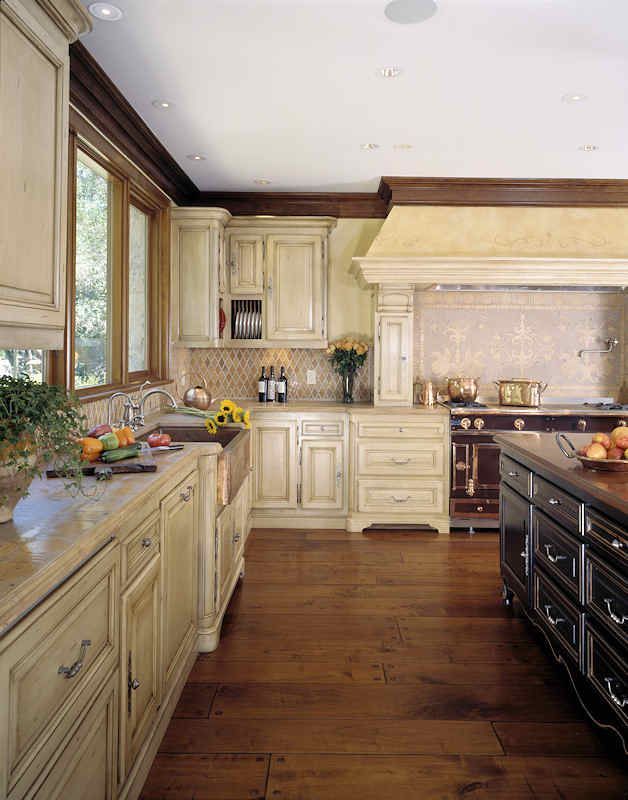 Elegant kitchen with light-colored cabinets, dark wood floor, and a dark-red stove.